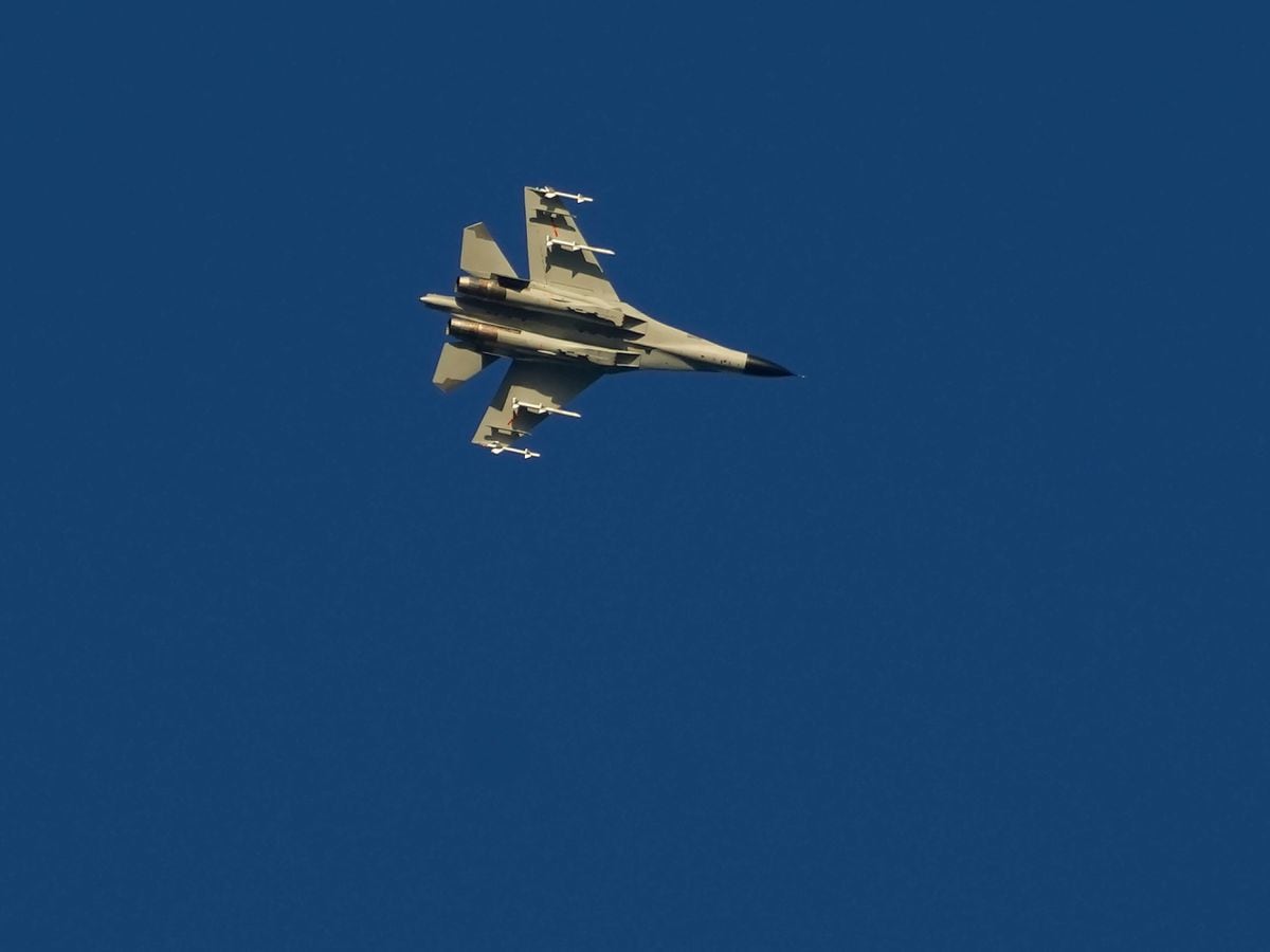 A military fighter jet flies over the Taiwan Strait