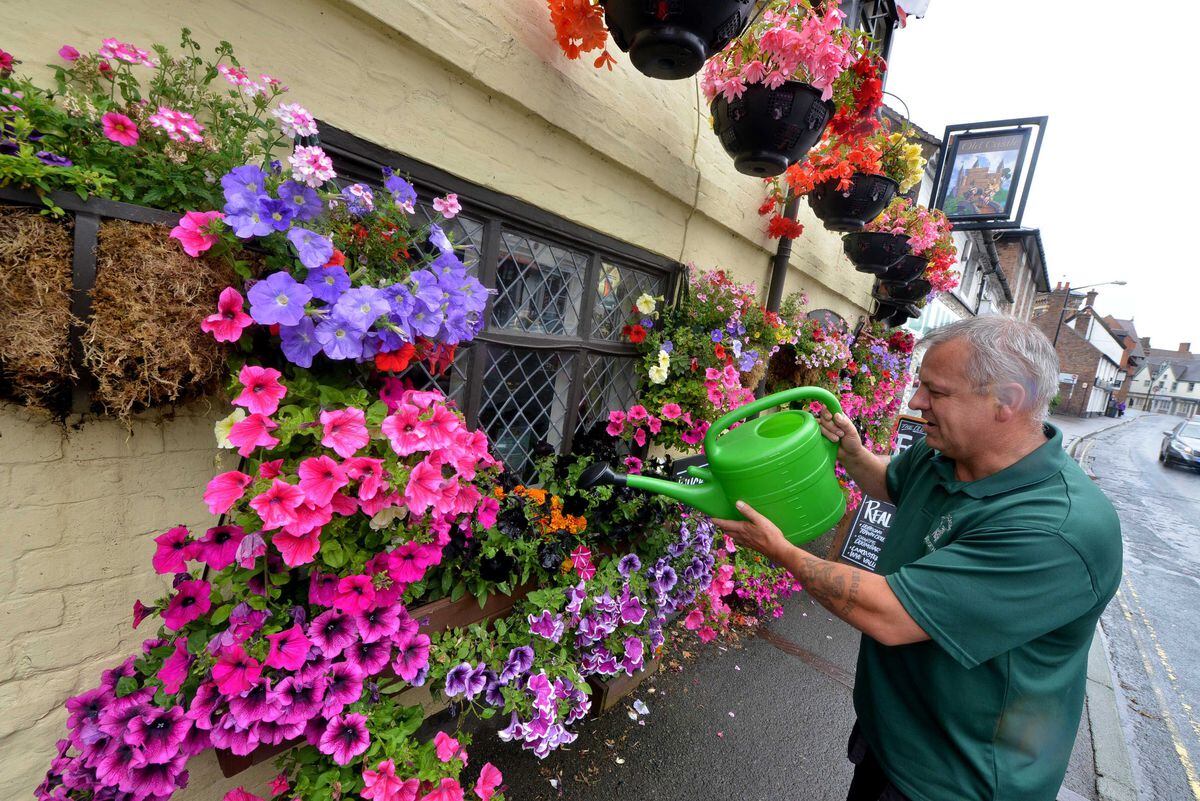 The Old Castle Pub, Bridgnorth. Pictured: Landlord Bryn Masterman watering his flower pots which he grows each year to make for a pretty sight at the front of the building.