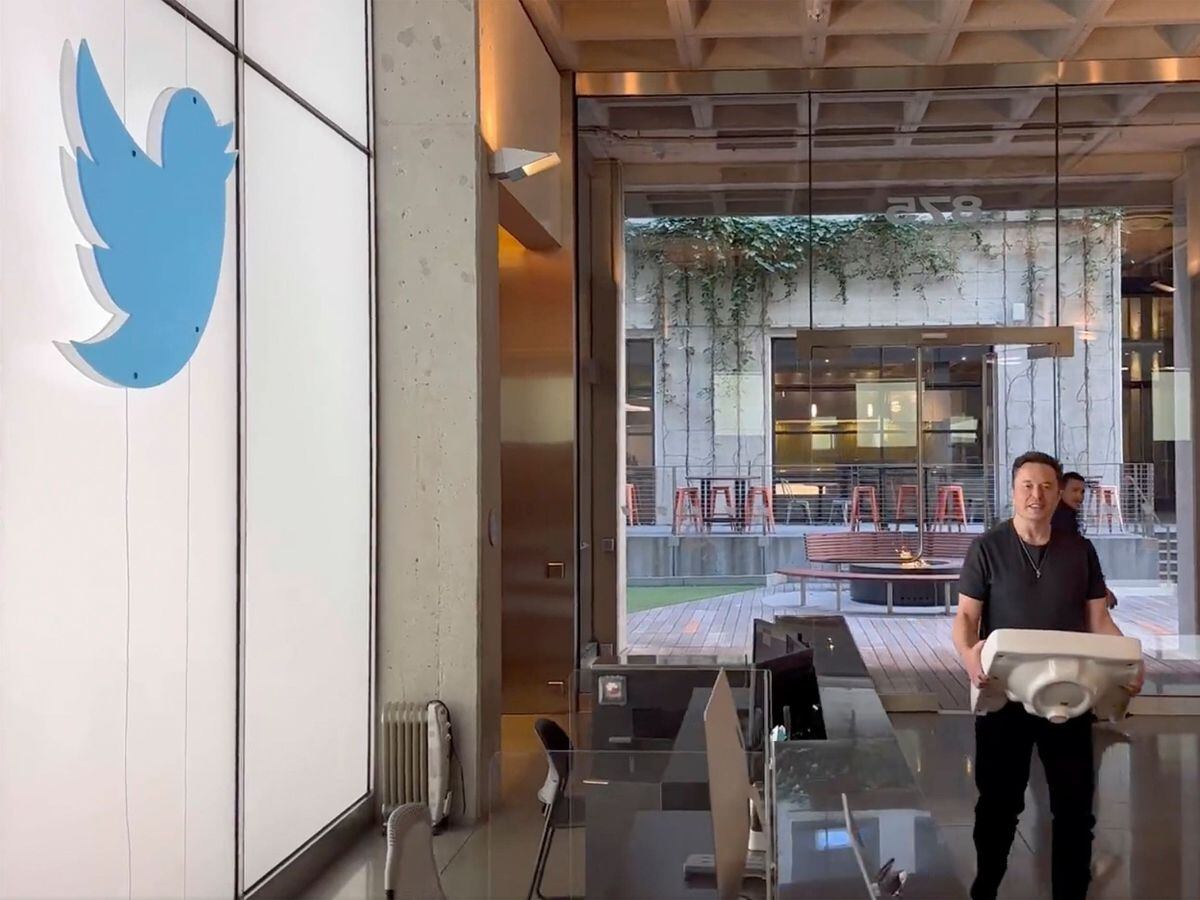 This image from Elon Musk's Twitter page shows Mr. Musk entering Twitter's headquarters with a sink through the lobby area in San Francisco