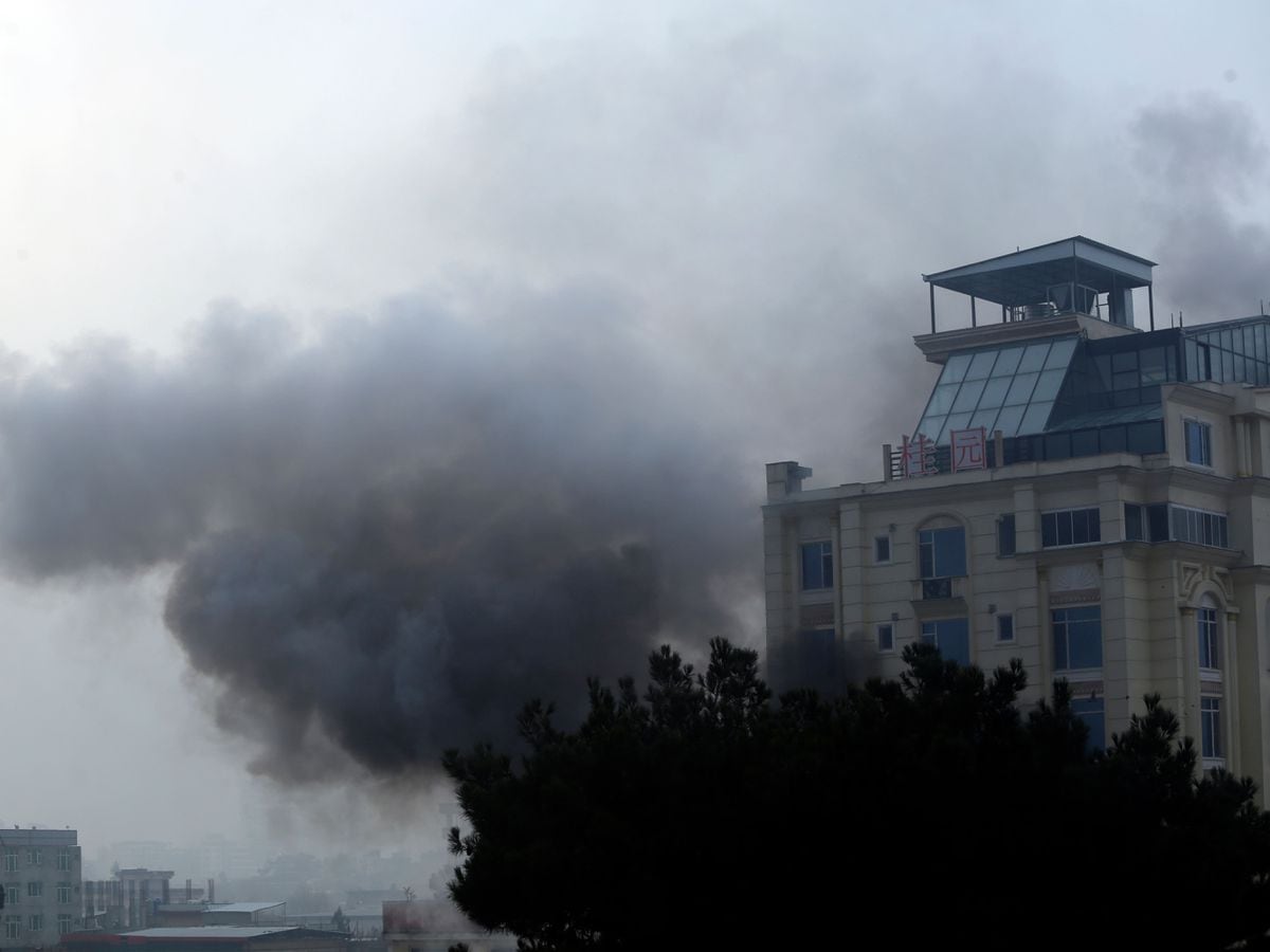 Smoke rises from a hotel building after explosions and gunfire in Kabul, Afghanistan, Monday, December 12, 2022