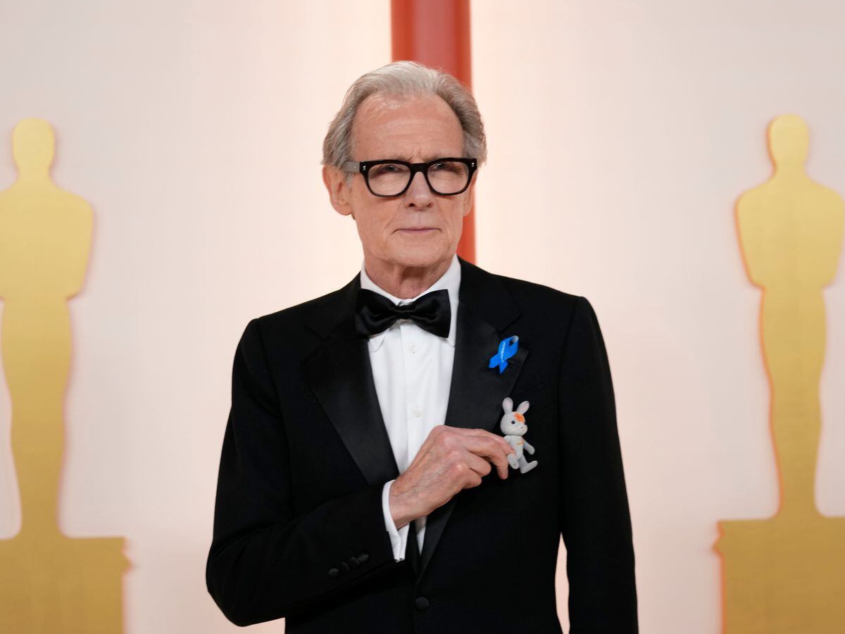 Bill Nighy wears blue ribbon at Oscars in solidarity with displaced