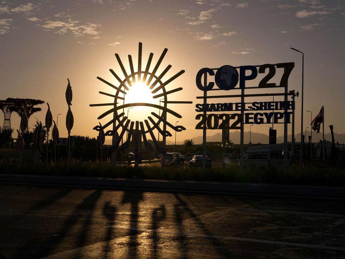 The sun sets behind the Cop27 sign outside the venue of the Cop27 UN climate summit in Sharm El Sheikh, Egypt