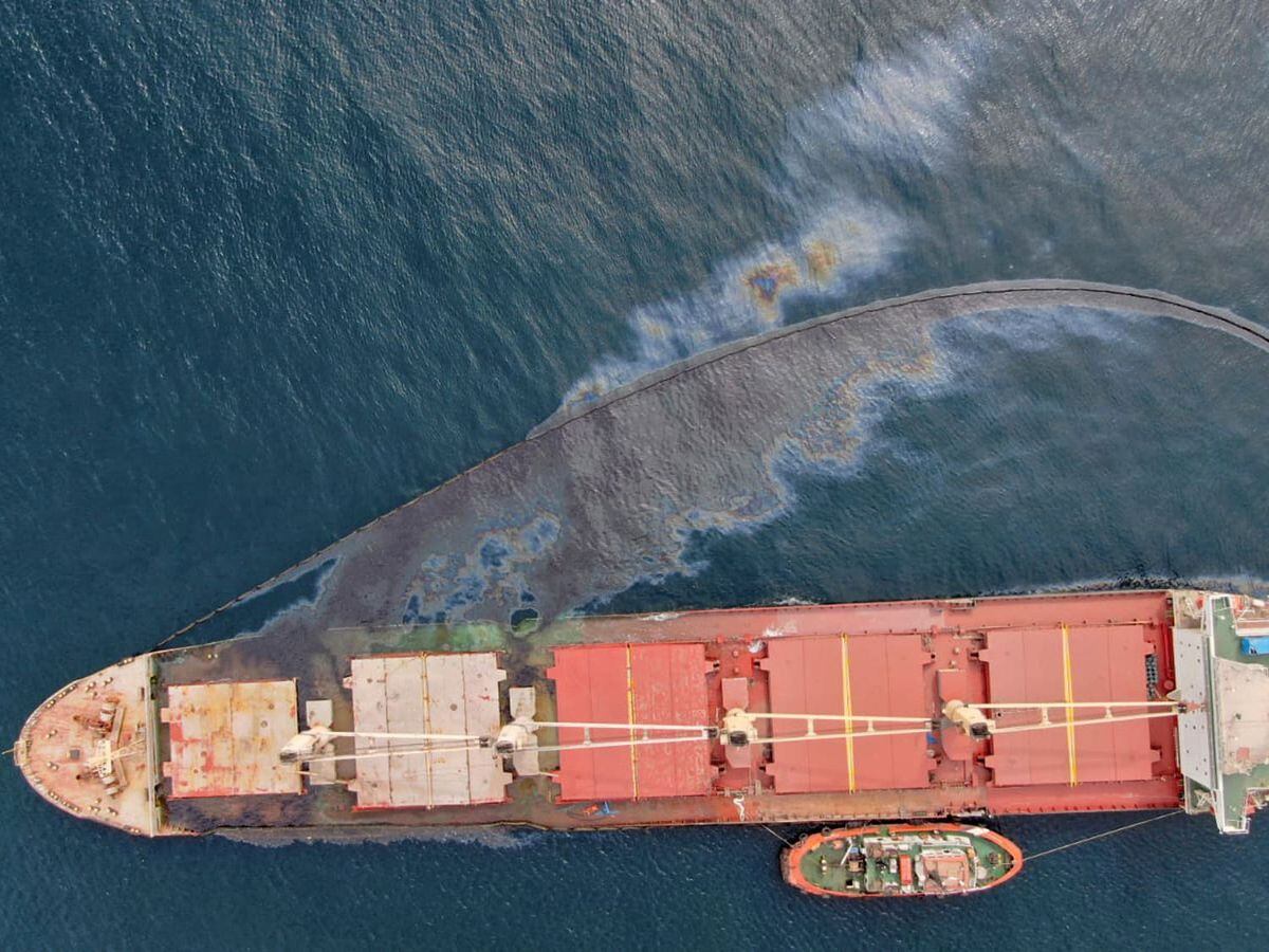 A leak of heavy fuel oil sits on the surface of the sea by the Tuvalu-registered OS 35 cargo ship that collided with a liquid natural gas carrier in the Bay of Gibraltar