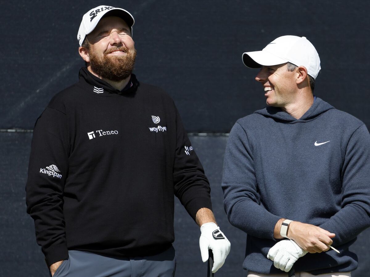 Open day three: Rory McIlroy supporting leader Shane Lowry after missing the cut