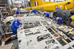 RAF Museum volunteers with the Dornier wing section. 