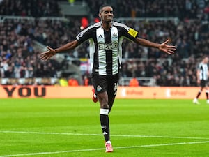 Alexander Isak, with his arms out, runs off to celebrate scoring