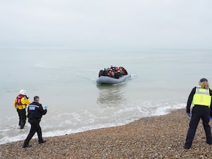 Officals wait to intercept a boatful of people thought to be migrants