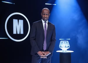 Host Clive Myrie with Mastermind glass bowl trophy