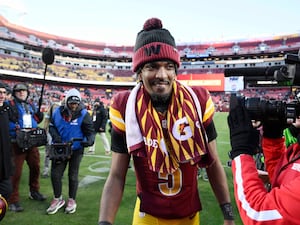 Washington Commanders quarterback Jayden Daniels heads off the field at the end of a thrilling win over the Philadelphia Eagles