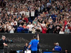 Novak Djokovic gestures to the crowd on Rod Laver Arena