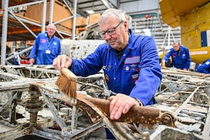 RAF Museum volunteer with the wing section