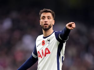 Rodrigo Bentancur points during a match for Tottenham