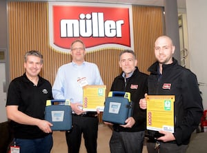 Friends of Grove School Co-Chairmen (Left) Jordan Machin and Chris Ingham receive donated defibrillators from Müller representatives Peter Short and Phil Watkins