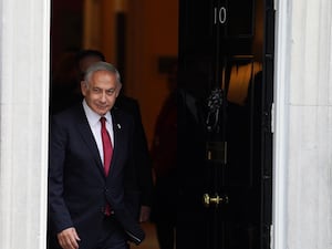 Israeli Prime Minister Benjamin Netanyahu walks out of the door of 10 Downing Street