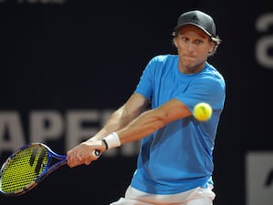 Diego Forlan returns the ball to Boris Arias and Federico Zeballos on his backhand