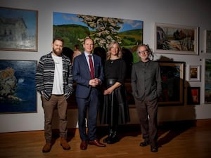 Songwriter Chris Bateman, Communities Minister Gordon Lyons, harpist Anne Harper and composer Peter Wilson (Duke Special) stand in front of paintings