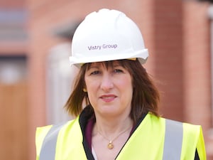 Rachel Reeves wearing a hard hat on a visit to a building site.