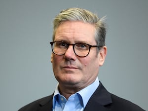 A close-up of Prime Minister Sir Keir Starmer, wearing glasses