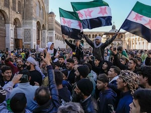 Syrians celebrating outside the Umayyad Mosque in Damascus