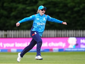 England’s Charlie Dean stretches out her arms to celebrate talking a wicket