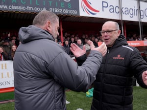 Tamworth manager Andy Peaks (right) greets Tottenham manager Ange Postecoglou