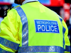 Metropolitan Police officer in hi-vis from behind