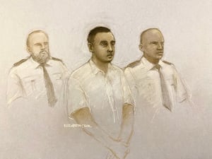 A court artist drawing of Nasen Saadi in court with two officers