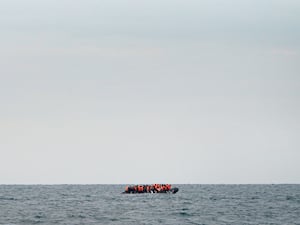 A group of people thought to be migrants crossing the Channel in a small boat travelling from the coast of France and heading in the direction of Dover, Kent, in August 2023