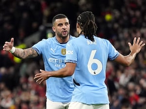 Kyle Walker and Nathan Ake have an animated discussion on the field