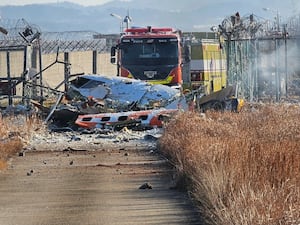 Fire engines work to extinguish a fire at the Muan International Airport in Muan, South Korea