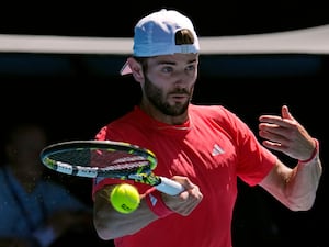 Jacob Fearnley plays a forehand at the Australian Open