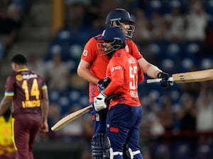 England batsmen Jamie Overton and Rehan Ahmed give each other a hug after defeating West Indies