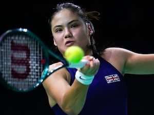 Emma Raducanu strikes a forehand against Viktoria Hruncakova