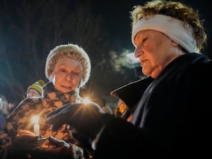 Supporters hold candles during a candlelight vigil outside the Wisconsin Capitol in Madiso