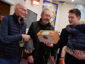 Fixers Piet Van den Ende and Terry Wells show Brecon, Radnor and Cwm Tawe MP David Chadwick and his eldest son William, a radio and coffee pot they were working on.