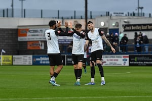 Remi Walker, centre, celebrates netting Bucks' third (Pic: Kieren Griffin)