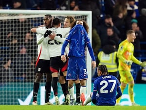 Chelsea’s Marc Cucurella stands dejected as Fulham players celebrate