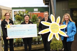 Coed-y-Dinas Store Manager, Nicola Beck (left), Seasonal Sales Assistant, Anya (second from the left) Seasonal Supervisor, Jemma (second from the right) and Lingen Davies Relationship Fundraiser Steph Smith staff (left) with cheque for Lingen Davies