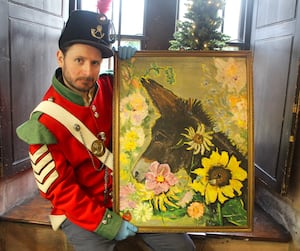 Dr Robert MacKinnon, of the Soldiers of Shropshire Museum, holds up the painting of Jessie the donkey