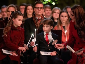 Princess Charlotte, Prince Louis and the Princess of Wales light candles during the Together At Christmas carol service