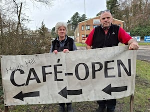 Debbie and John Johnson temporarily posing with the sign which they have removed from the council\'s land. Picture: LDRS