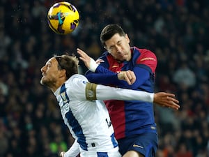 Leganes’ Sergio Gonzalez (left) and Barcelona’s Robert Lewandowski challenge for the ball