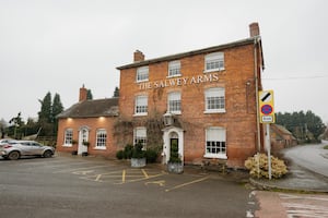 The Salway Arms is an elegant brick building with a welcoming glow