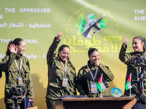 Israeli female soldier hostages Naama Levy, Daniella Gilboa, Karina Ariev and Liri Albag, in no particular order, salute a Palestinian crowd