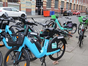 Tier, Lime and River e-bikes on a pavement in Chelsea, west London