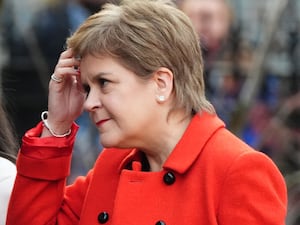 Nicola Sturgeon wearing a red coat