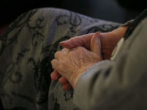 An elderly person's hands