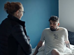 A bearded man with a police officer