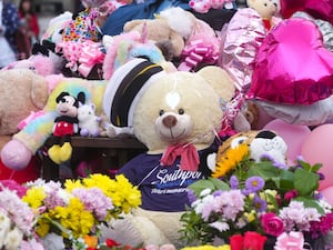 Teddies, baloons and flowers are laid in tribute to those killed and injured in the Southport attack