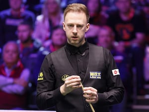 Judd Trump looks on